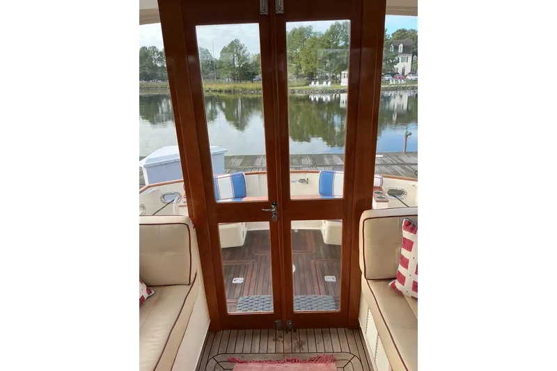 Slide: The Image of Interior view of 2007 Legacy Yachts 32, featuring wooden doors and waterfront scenery. - 6