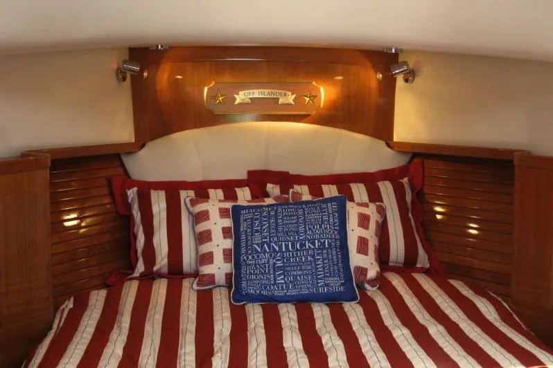 Slide: The Image of Cozy cabin interior of 2007 Legacy Yachts 32 with striped bedding and decorative pillows. - 7