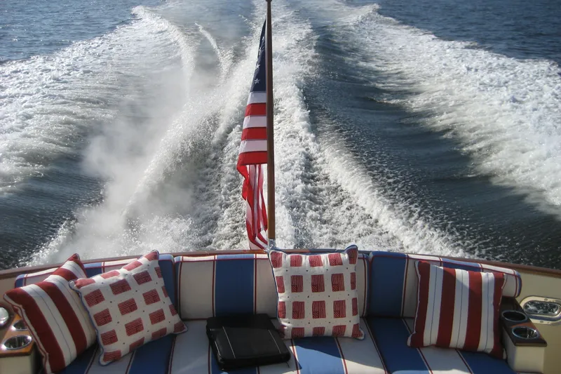 Slide: The Image of Rear view of 2007 Legacy Yachts 32, featuring wake and patriotic-themed cushions. - 8