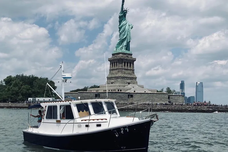 Slide: The Image of Boat near Statue of Liberty, Flye Point 31, 1993 model, on a sunny day. - 2