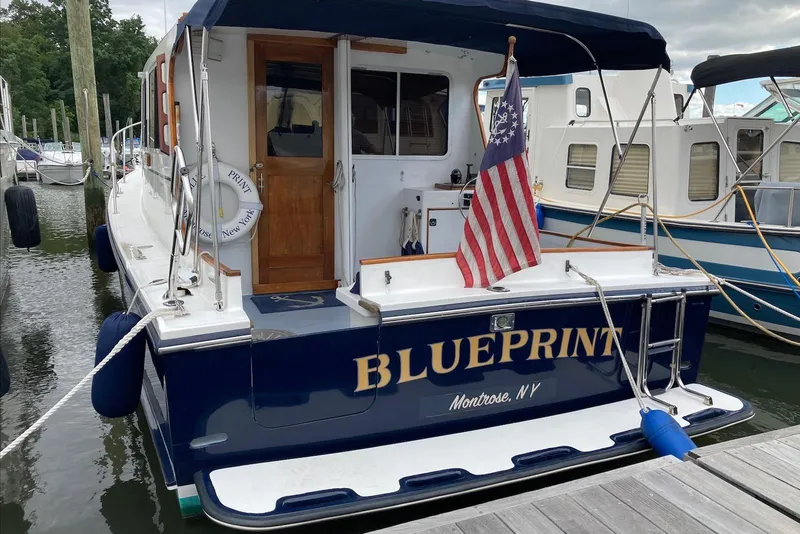 Slide: The Image of Flye Point 31 boat, "Blueprint," docked with American flag, Montrose, NY, 1993 model. - 4