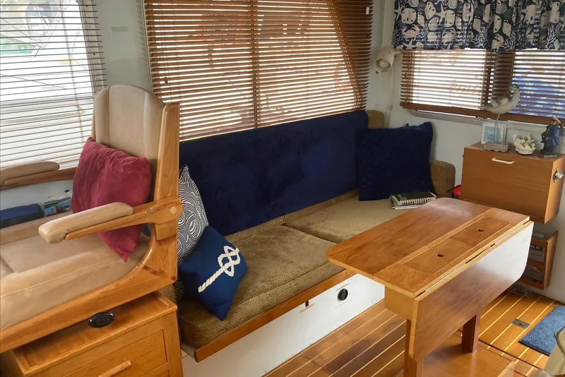 Slide: The Image of Cozy 1993 Flye Point 31 boat interior with wooden furniture and nautical decor. - 7