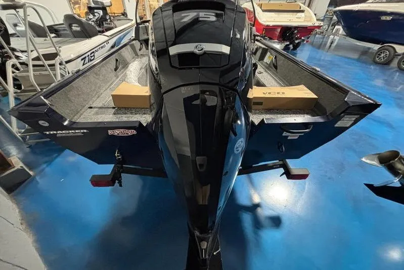 Slide: The Image of 2026 Tracker Pro Guide V-16 WT boat with 75 HP engine in showroom. - 10
