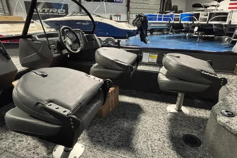 Slide: The Image of 2026 Tracker Pro Guide V-16 WT boat interior with swivel seats and steering console. - 9