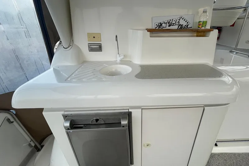Slide: The Image of 1997 Cruisers Yachts 3650 Aft Cabin interior with sink and mini fridge. - 14