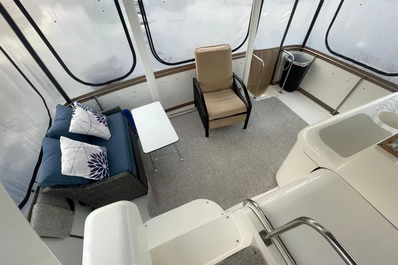 Slide: The Image of 1997 Cruisers Yachts 3650 Aft Cabin interior with seating area and table. - 16