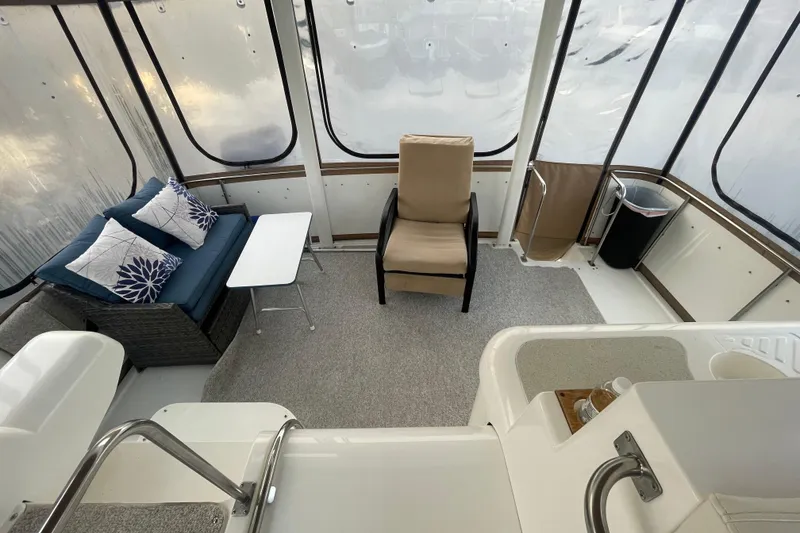 Slide: The Image of 1997 Cruisers Yachts 3650 Aft Cabin interior with seating, table, and carpeted floor. - 17