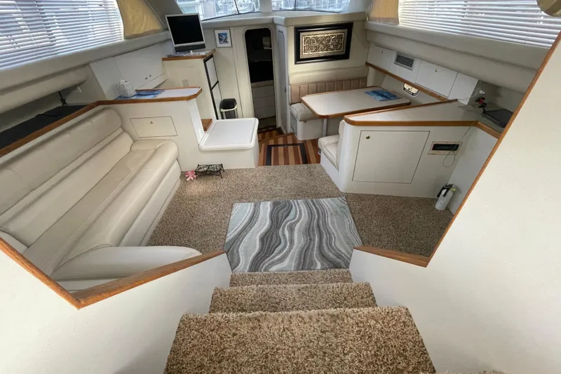 Slide: The Image of 1997 Cruisers Yachts 3650 Aft Cabin interior with plush seating and elegant decor. - 18