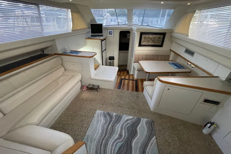 Slide: The Image of Luxurious interior of 1997 Cruisers Yachts 3650 Aft Cabin with elegant seating and dining area. - 20