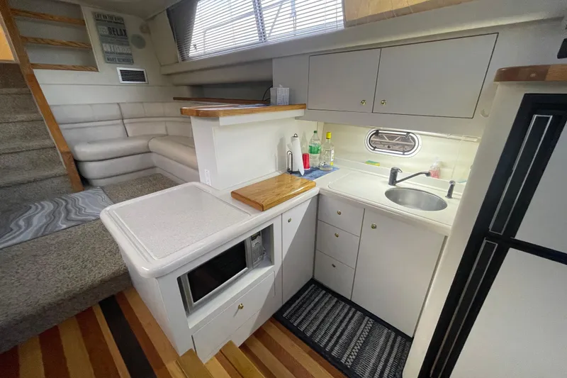 Slide: The Image of 1997 Cruisers Yachts 3650 Aft Cabin interior with kitchenette and seating area. - 22