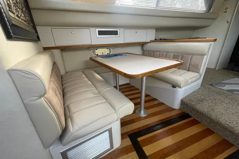 Slide: The Image of 1997 Cruisers Yachts 3650 Aft Cabin interior with dining area and cushioned seating. - 24