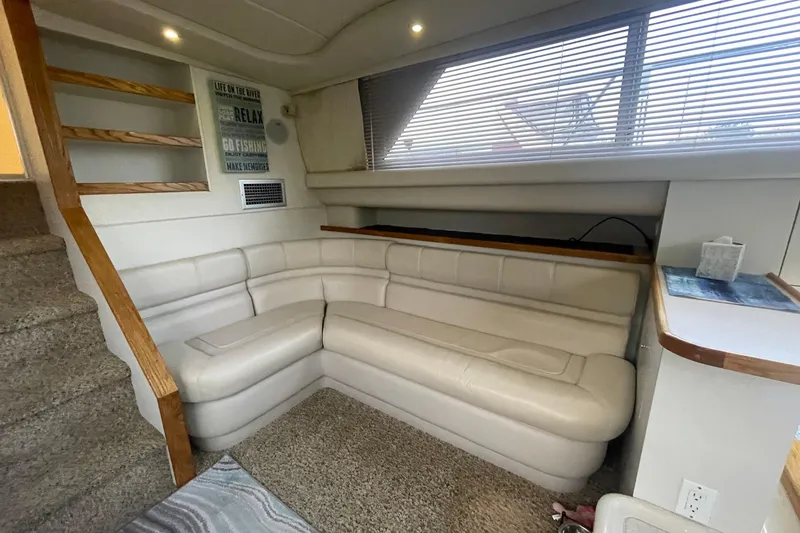 Slide: The Image of 1997 Cruisers Yachts 3650 Aft Cabin interior with beige seating and wooden accents. - 26
