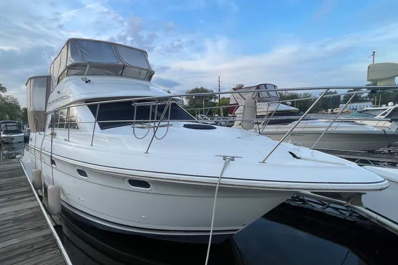 Slide: The Image of 1997 Cruisers Yachts 3650 Aft Cabin docked, showcasing sleek design and spacious cabin. - 3