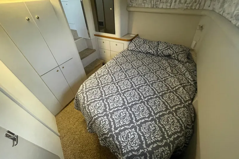 Slide: The Image of 1997 Cruisers Yachts 3650 Aft Cabin bedroom with patterned bedding and storage cabinets. - 30