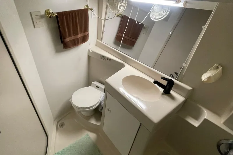 Slide: The Image of 1997 Cruisers Yachts 3650 Aft Cabin bathroom with sink, toilet, and mirror. - 32