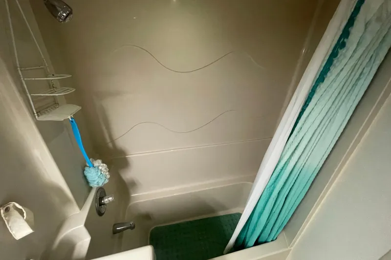 Slide: The Image of 1997 Cruisers Yachts 3650 Aft Cabin bathroom with shower, curtain, and bath accessories. - 33