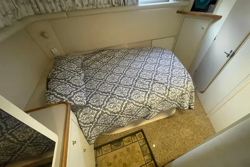 Slide: The Image of 1997 Cruisers Yachts 3650 Aft Cabin bedroom with patterned bedding and carpeted floor. - 34