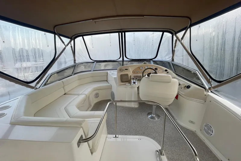 Slide: The Image of 1997 Cruisers Yachts 3650 Aft Cabin interior with helm and seating area. - 6