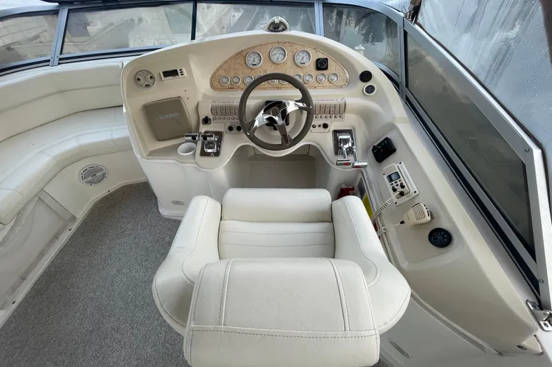 Slide: The Image of 1997 Cruisers Yachts 3650 Aft Cabin helm with steering wheel and navigation instruments. - 8