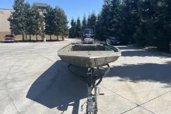 Slide: The Image of 2019 Tracker Grizzly 1860 CC boat on trailer in sunny outdoor setting. - 10