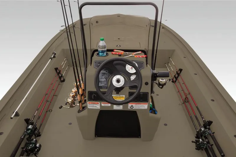 Slide: The Image of 2019 Tracker Grizzly 1860 CC boat interior with fishing rods and steering console. - 22