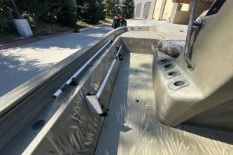 Slide: The Image of 2019 Tracker Grizzly 1860 CC boat interior with rod holders and seating. - 4