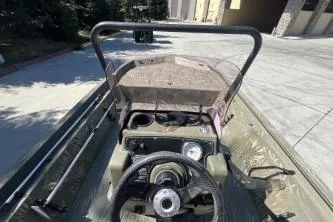 Slide: The Image of 2019 Tracker Grizzly 1860 CC boat interior with steering wheel and controls. - 5