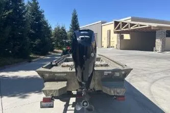 Slide: The Image of 2019 Tracker Grizzly 1860 CC boat with outboard motor in a driveway. - 9