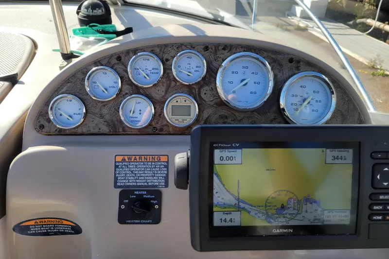 Slide: The Image of Dashboard of a 2003 Bayliner 245 boat with gauges and Garmin GPS. - 11
