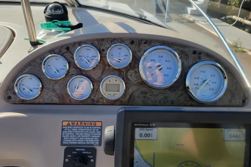 Slide: The Image of Dashboard of a 2003 Bayliner 245 boat with gauges and GPS display. - 15