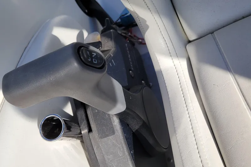 Slide: The Image of Throttle control of a 2003 Bayliner 245 boat, featuring a sleek design and comfortable seating. - 17