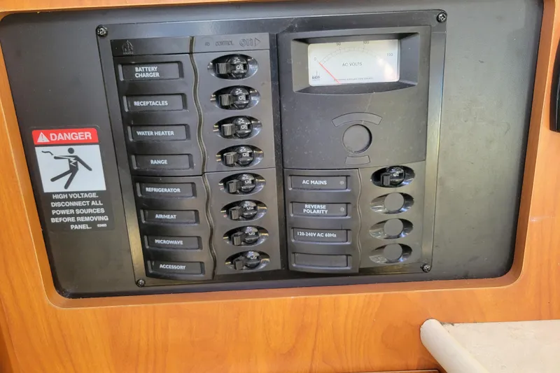 Slide: The Image of Electrical panel of a 2003 Bayliner 245 boat with labeled switches and voltage meter. - 20