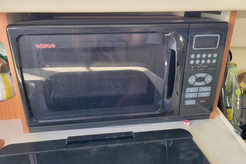 Slide: The Image of Microwave oven inside a 2003 Bayliner 245 boat kitchen area. - 22