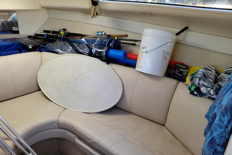 Slide: The Image of Interior of a 2003 Bayliner 245 boat with fishing gear and supplies. - 25