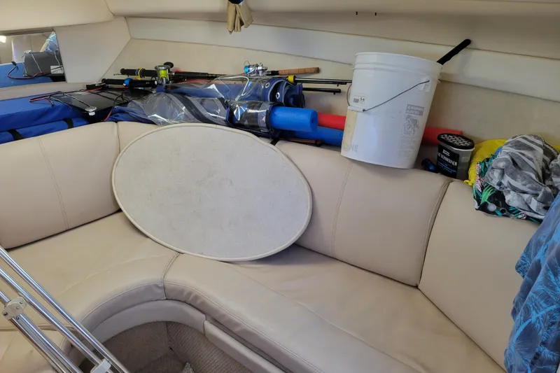 Slide: The Image of Interior of a 2003 Bayliner 245 boat with fishing gear and supplies. - 27