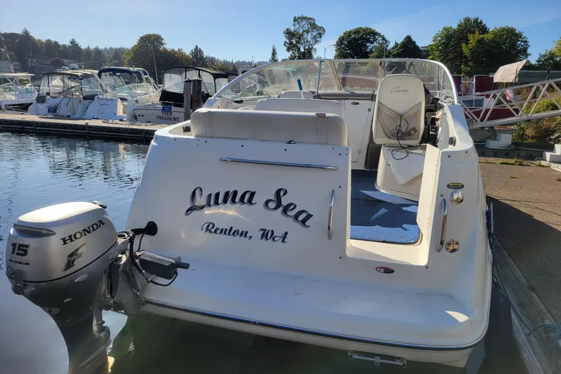 Slide: The Image of 2003 Bayliner 245 boat named "Luna Sea" docked, featuring a Honda outboard motor. - 3