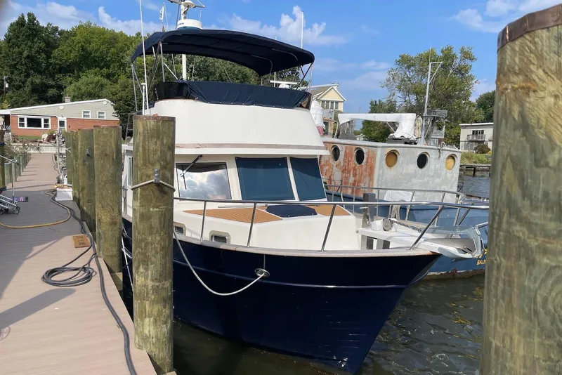 The Image of 2005 Mariner 38 Orient yacht docked at marina under cloudy sky. - 0
