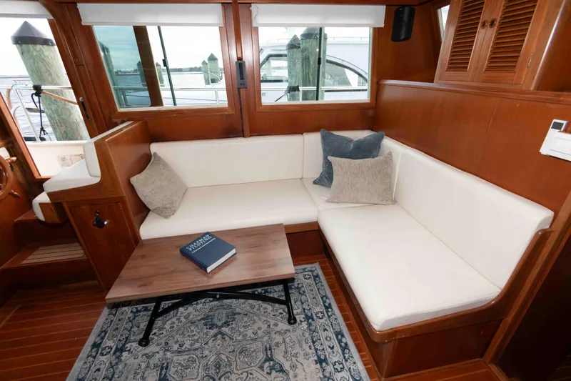Slide: The Image of Luxurious interior of 2005 Mariner 38 Orient yacht with white seating and wooden accents. - 11
