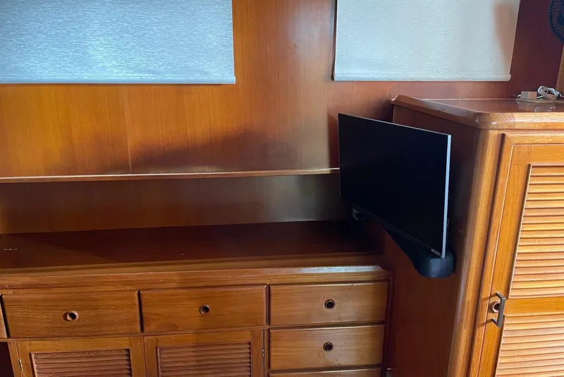 Slide: The Image of Interior of 2005 Mariner 38 Orient boat with navigation equipment and wooden helm. - 14