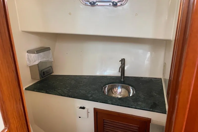 Slide: The Image of Pilothouse of 2005 Mariner 38 Orient yacht with wooden wheel and navigation equipment. - 16