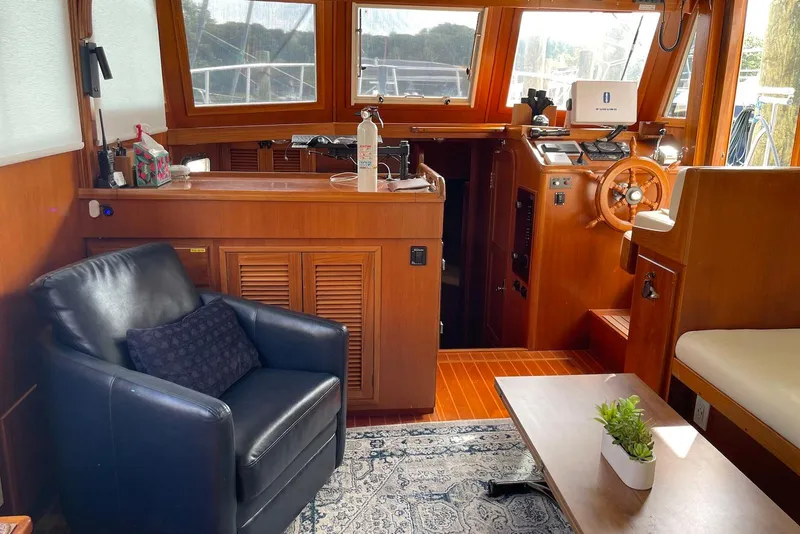 Slide: The Image of 2005 Mariner 38 Orient yacht kitchen with wood cabinetry, sink, and appliances. - 17