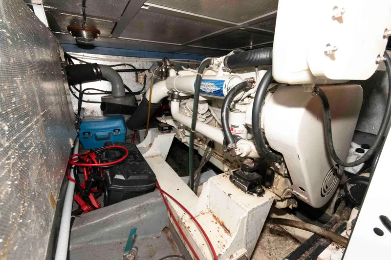 Slide: The Image of Engine room of 2005 Mariner 38 Orient boat, featuring mechanical components and wiring. - 23