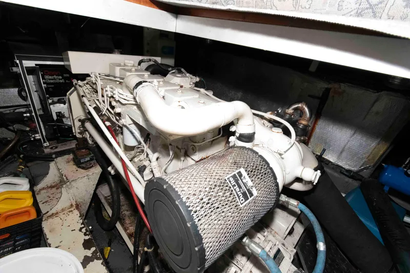 Slide: The Image of Engine room of 2005 Mariner 38 Orient boat, featuring a diesel engine and various components. - 24