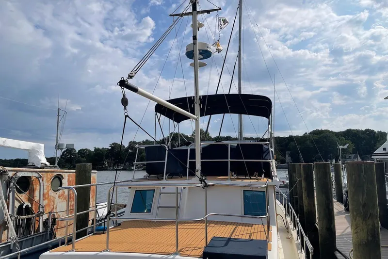 Slide: The Image of Flybridge of 2005 Mariner 38 Orient yacht with helm, seating, and marina view. - 4