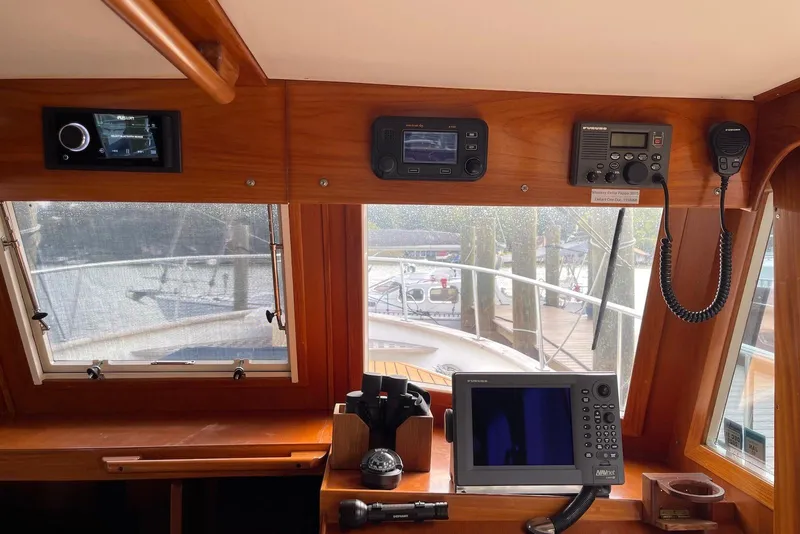 Slide: The Image of Bow view of 2005 Mariner 38 Orient yacht docked at a marina. - 8