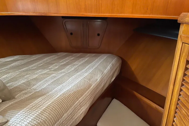 Slide: The Image of 2005 Mariner 38 Orient yacht docked at marina with wooden deck and railing. - 9