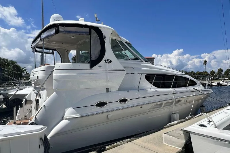 The Image of 2004 Sea Ray 390 Motor Yacht docked at marina under blue sky. - 0
