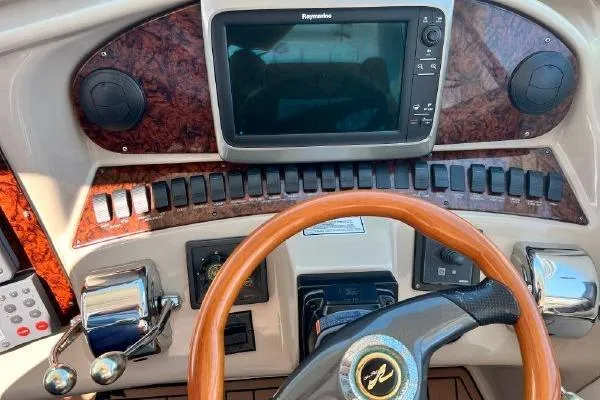 Slide: The Image of Dashboard of a 2004 Sea Ray 390 Motor Yacht with navigation controls. - 10