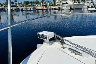 Slide: The Image of 2004 Sea Ray 390 Motor Yacht at marina, featuring anchor and calm waters. - 12