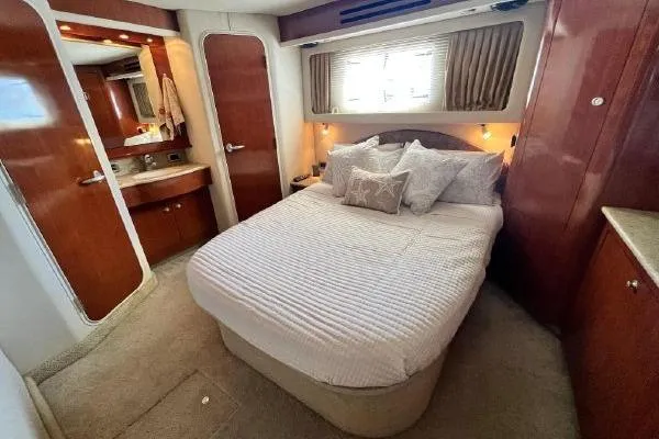 Slide: The Image of Luxurious bedroom interior of 2004 Sea Ray 390 Motor Yacht with cozy bed and elegant decor. - 16